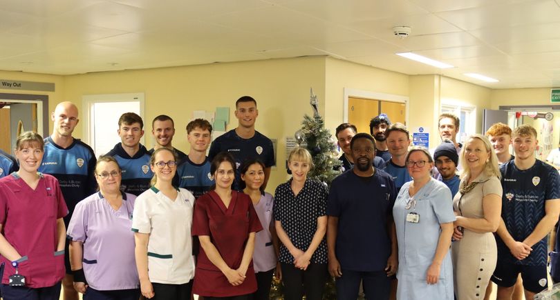 Cricket club members with NHS staff